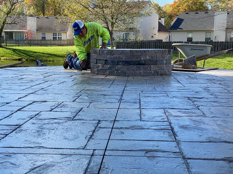 Indianapolis Decorative and Stamped Concrete. Concrete contractor working on stamped concrete patio and built in outdoor fire pit