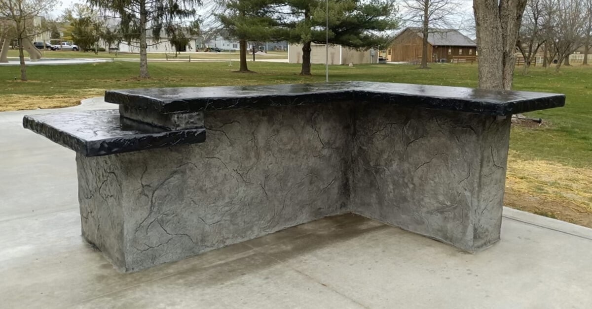 concrete patio kitchen - concrete bar with black granite countertops